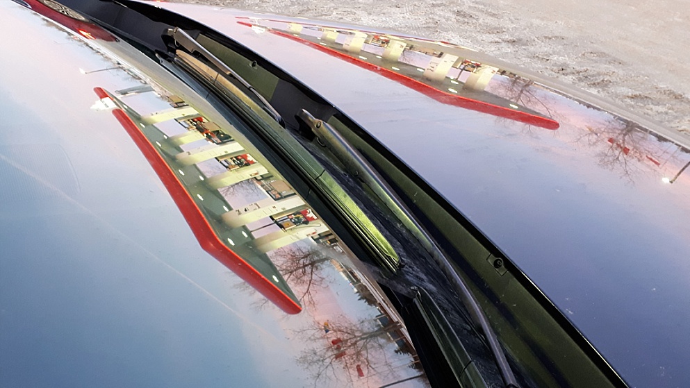 Gas stationreflection in windshield and hood