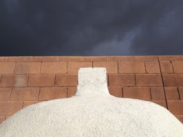 Fireplace, brick wall and storm clouds