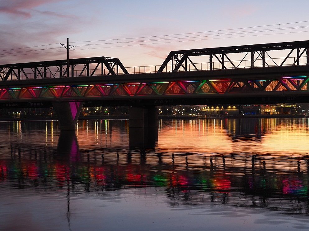 Showing sunset reflection in water with bridge