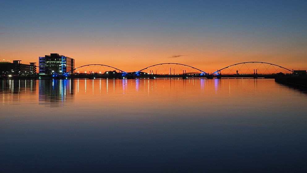 Sunset backlighting bridge in distance