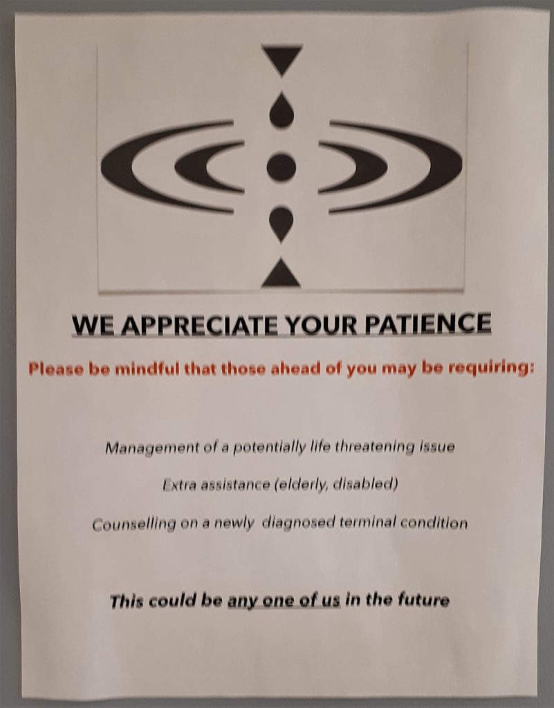 Sign urging patience in doctor's office