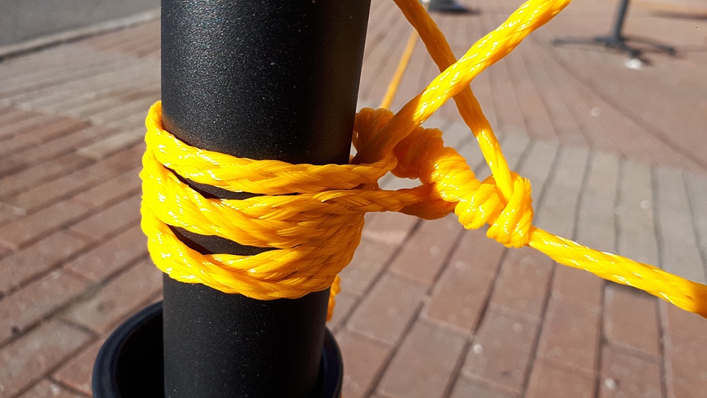 Yellow nylon rope on black stanchion