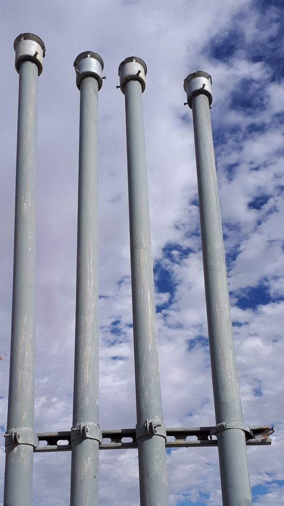 Four vertical pipes at gas station