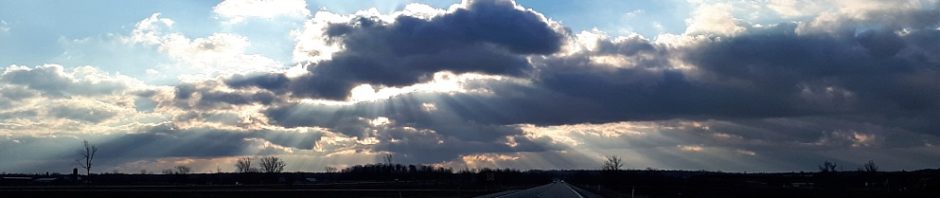 Early-morning shafts of light through low-lying clouds