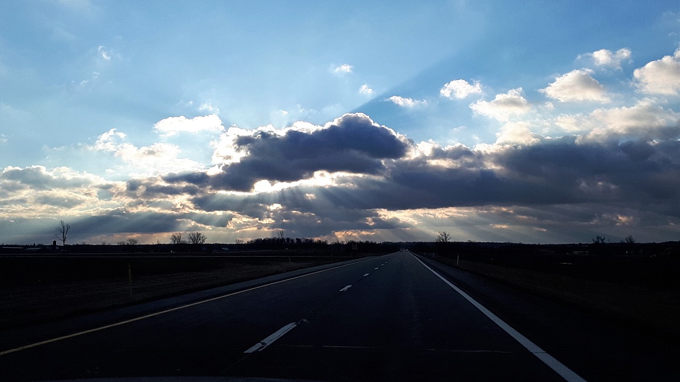 Early-morning shafts of light through low-lying clouds